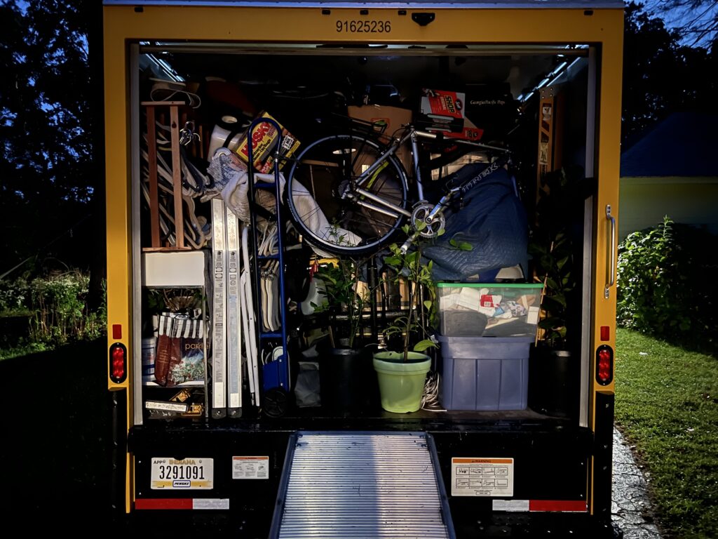 A picture of a fully packed moving truck as seen from the rear.